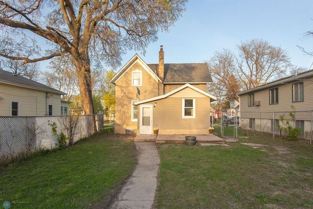 rear view of property featuring a yard