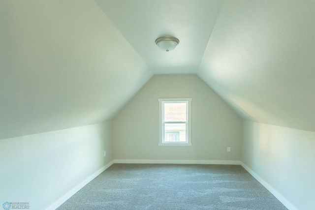 bonus room featuring carpet flooring and vaulted ceiling