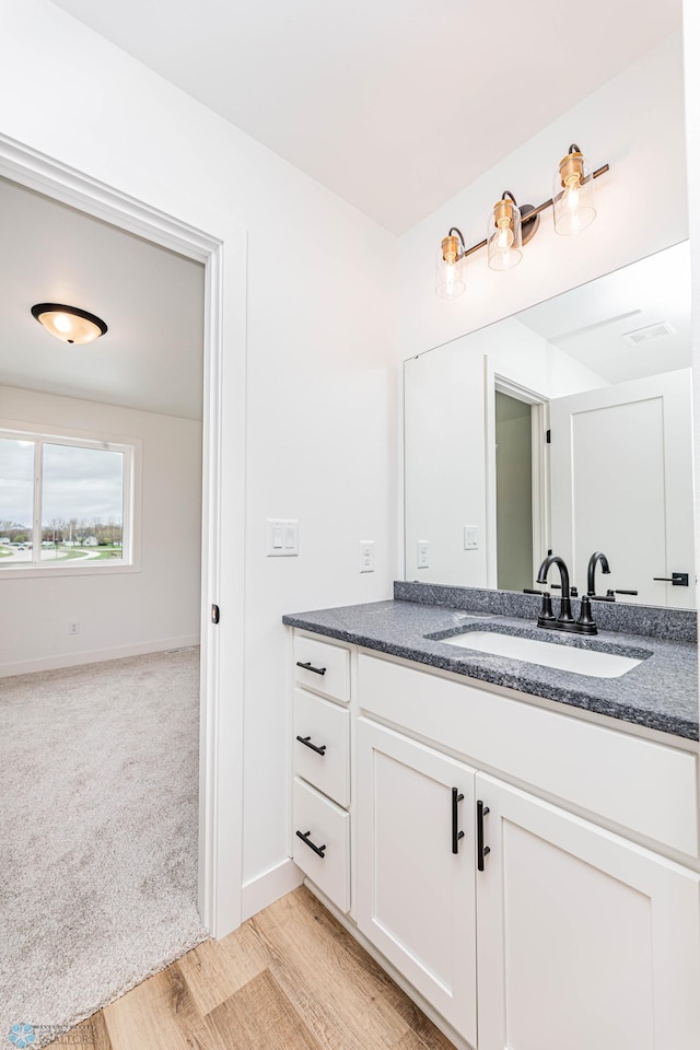 bathroom with wood-type flooring and vanity