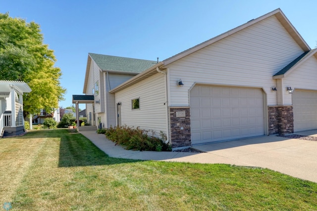 view of property exterior with a garage and a yard