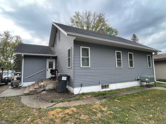 rear view of house with a yard and a patio area