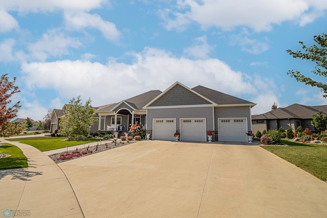 craftsman inspired home featuring a garage and a front lawn