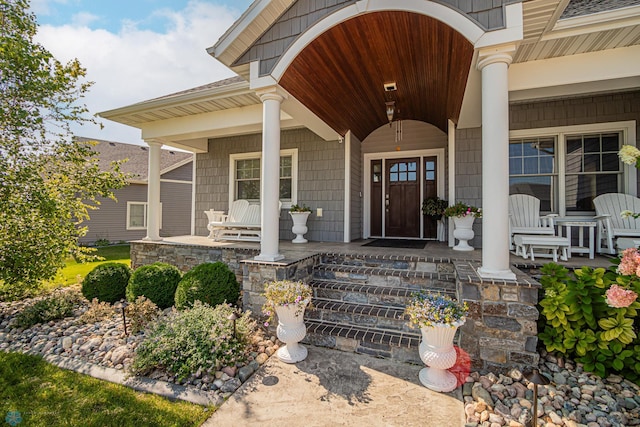 view of exterior entry with covered porch