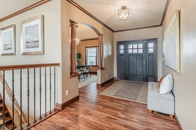 foyer featuring ornamental molding, a chandelier, and hardwood / wood-style flooring