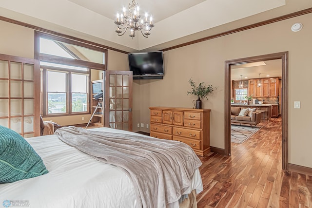 bedroom with hardwood / wood-style flooring and a chandelier