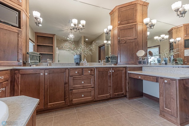 bathroom with vanity, tile patterned flooring, and a chandelier