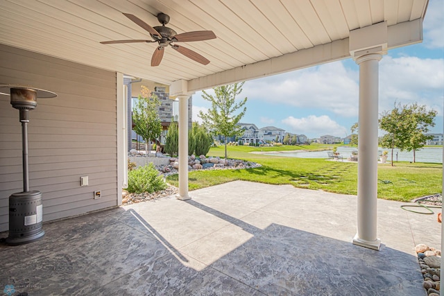 view of patio / terrace featuring ceiling fan and a water view