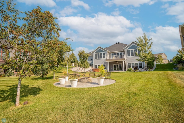 back of house featuring a lawn and a patio area