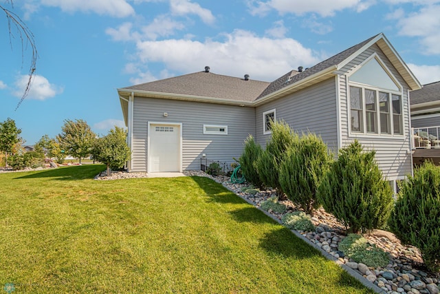 rear view of house featuring a yard