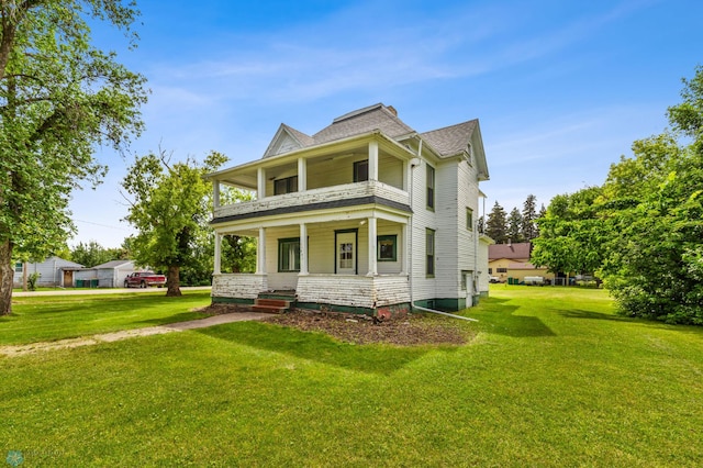 view of front of property featuring covered porch and a front yard