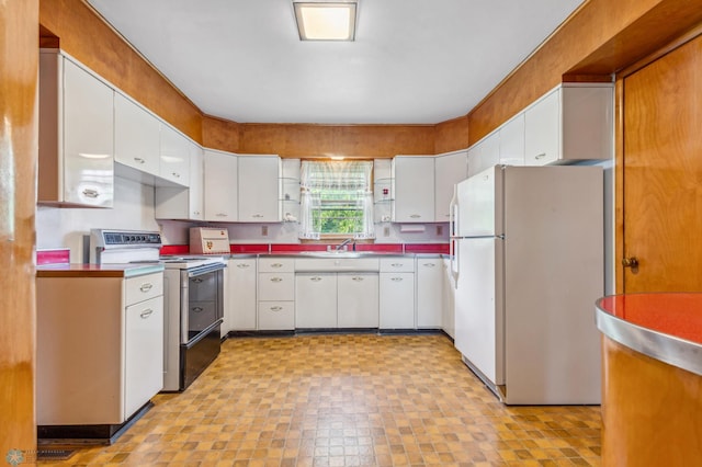 kitchen with white appliances, sink, and white cabinets