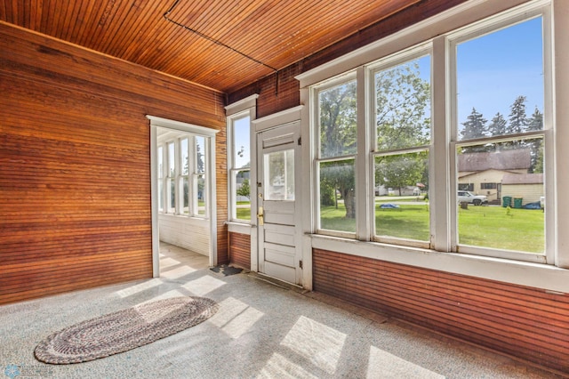 unfurnished sunroom featuring wood ceiling