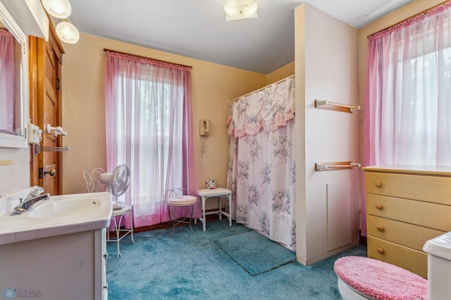 bathroom with a shower with shower curtain, vanity, and toilet