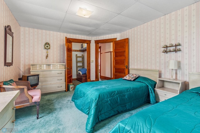 carpeted bedroom with a drop ceiling