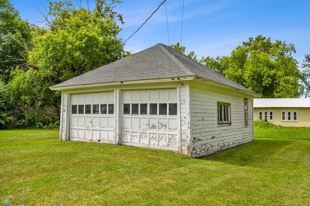 garage featuring a lawn