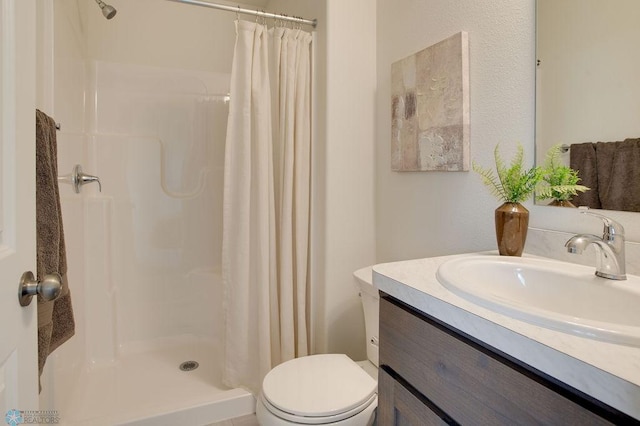 bathroom featuring walk in shower, vanity, and toilet