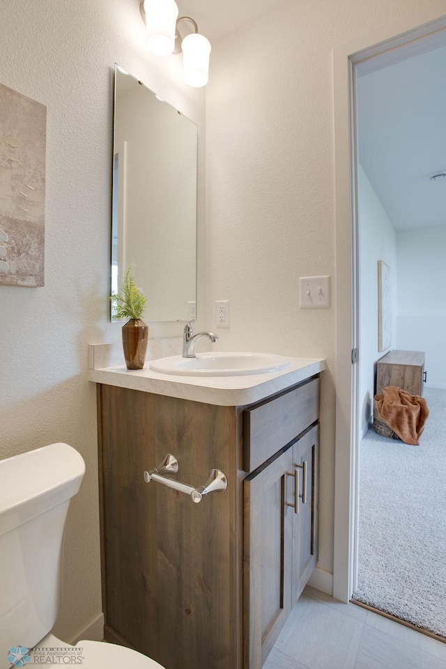 bathroom with tile patterned floors, vanity, and toilet