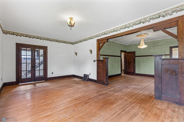 spare room featuring ornamental molding, hardwood / wood-style floors, and french doors