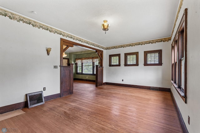 unfurnished room with hardwood / wood-style floors