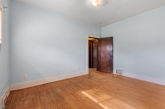 spare room featuring light hardwood / wood-style flooring