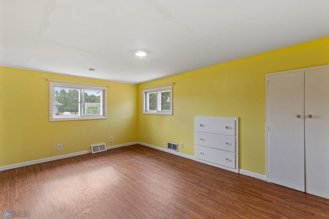 unfurnished bedroom with hardwood / wood-style floors