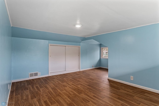 unfurnished bedroom featuring dark hardwood / wood-style flooring and a closet