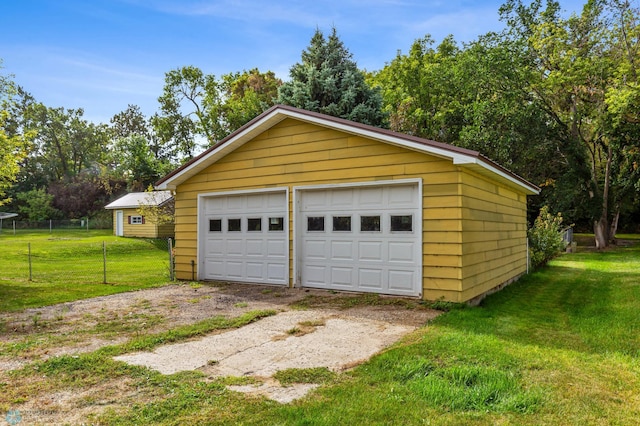 garage featuring wood walls and a lawn