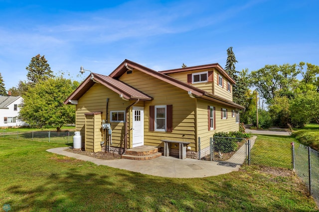 rear view of house featuring a yard