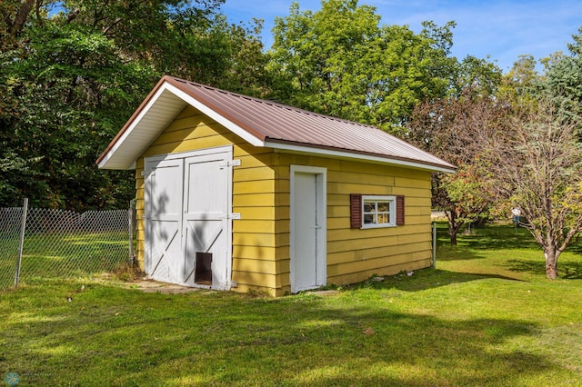 view of outbuilding featuring a yard