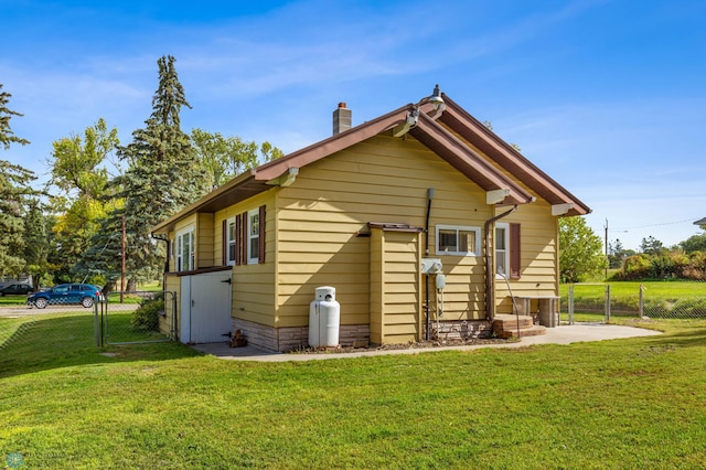 back of house with a patio and a yard