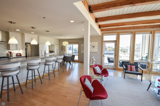 living room featuring light wood-type flooring and beam ceiling