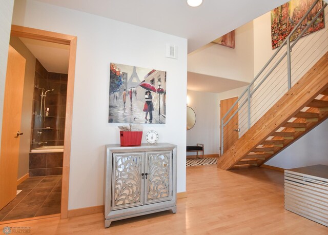 hall with wood-type flooring