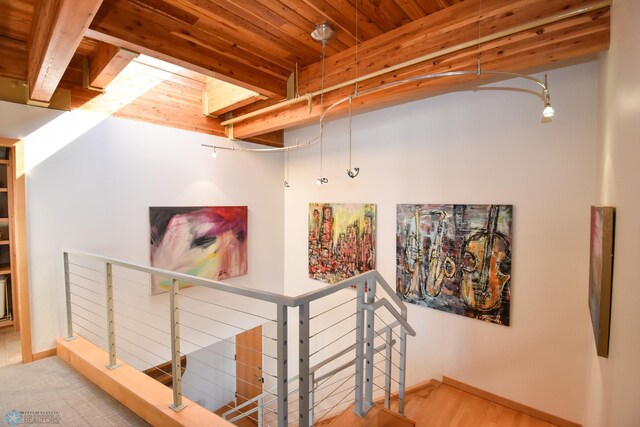 hallway featuring wood-type flooring, beam ceiling, and wooden ceiling