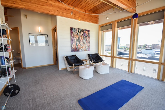 living area with wooden ceiling, lofted ceiling with beams, and carpet floors