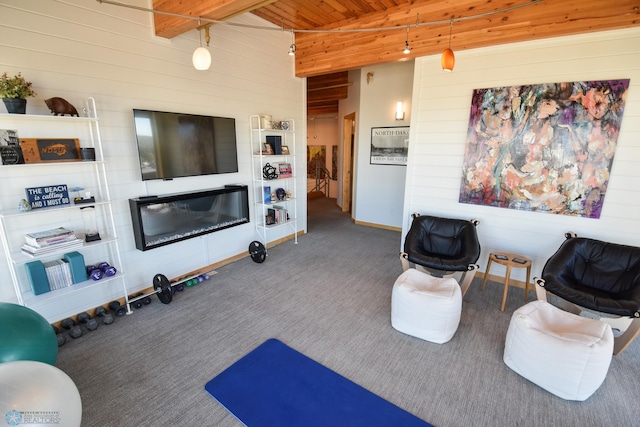 carpeted living room with beam ceiling and wooden ceiling