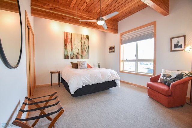 carpeted bedroom with ceiling fan, beamed ceiling, and wooden ceiling