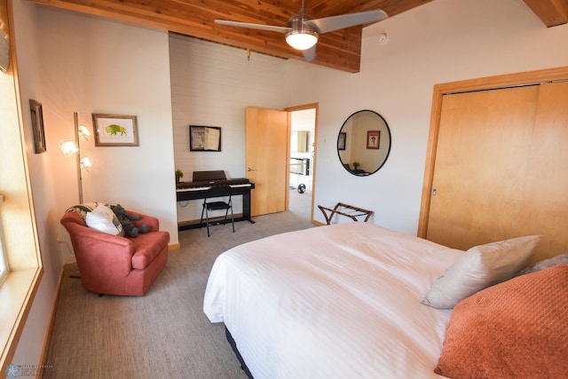 bedroom featuring ceiling fan, a closet, lofted ceiling with beams, and carpet