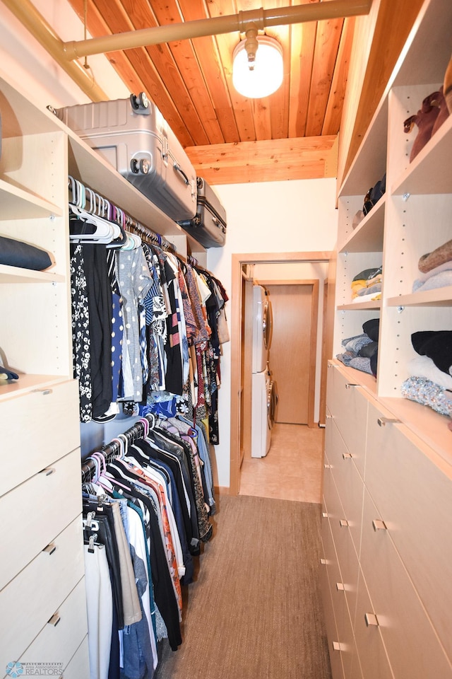 walk in closet featuring stacked washer / dryer