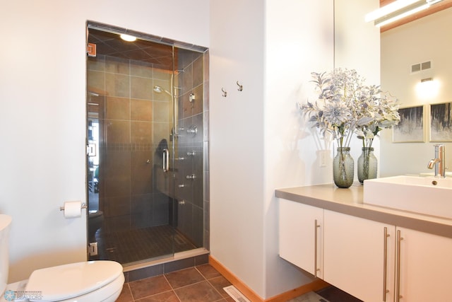 bathroom with walk in shower, vanity, toilet, and tile patterned floors