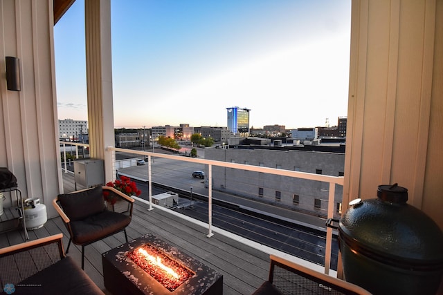 balcony at dusk with an outdoor fire pit