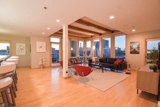 living room with light wood-type flooring and beamed ceiling