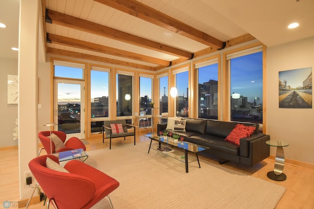 living room with light hardwood / wood-style flooring and beam ceiling