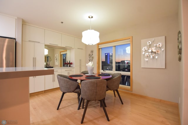 dining space with light hardwood / wood-style flooring