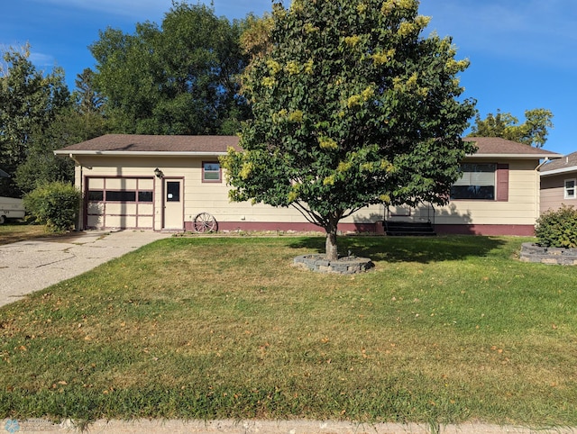 obstructed view of property with a garage and a front lawn