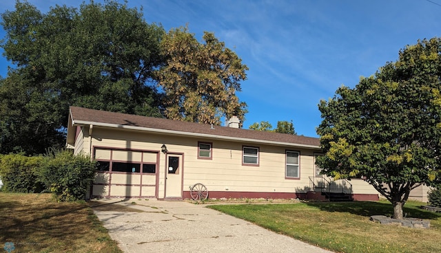 ranch-style house with a garage and a front lawn