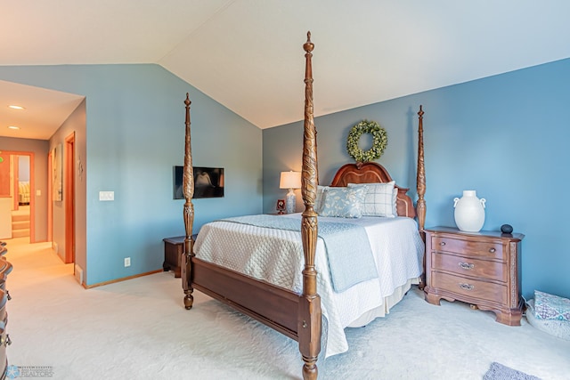 carpeted bedroom featuring lofted ceiling