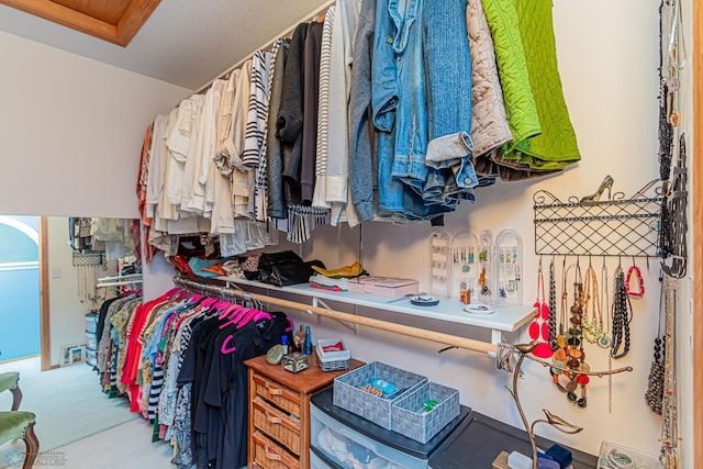 walk in closet featuring carpet flooring