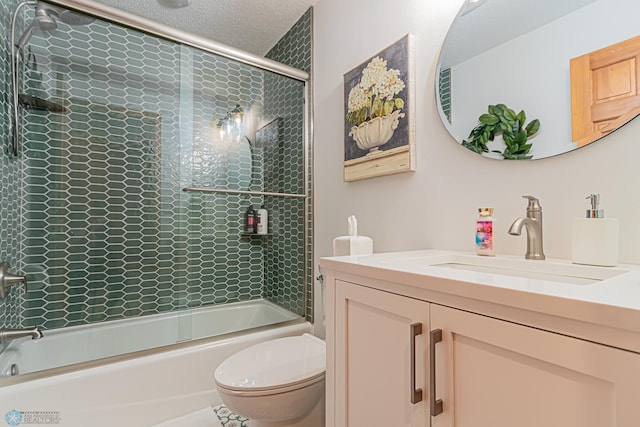 full bathroom featuring enclosed tub / shower combo, vanity, toilet, and a textured ceiling