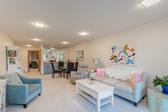 carpeted living room featuring a textured ceiling