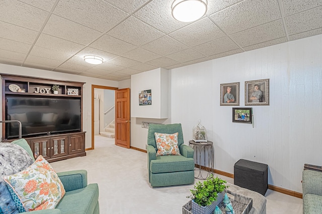 living room with carpet floors and a paneled ceiling